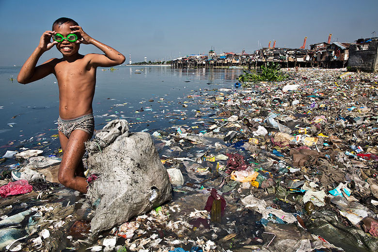 This boy spends each morning looking for recyclable plastic that he can sell for 35 cents/kilo to support his family