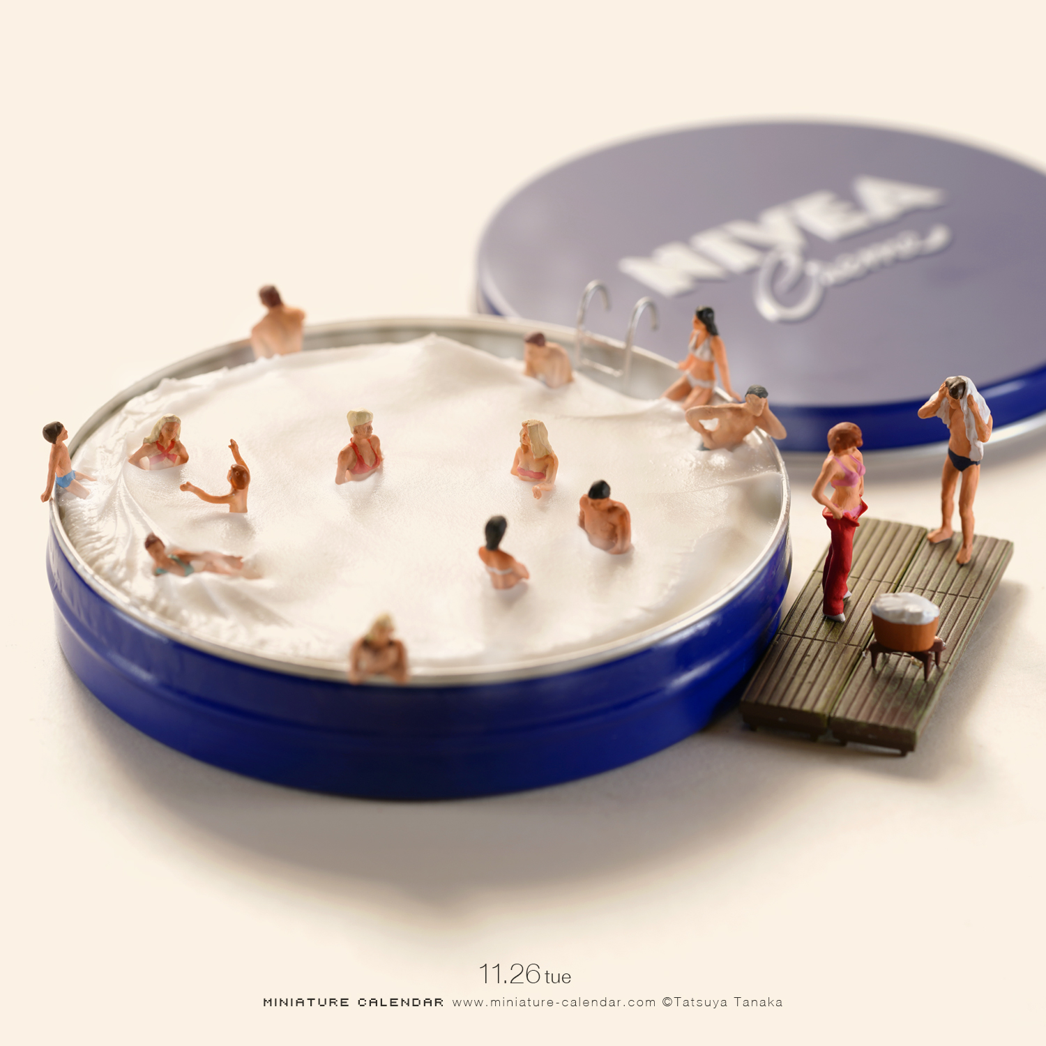 Miniature people swimming in a Nivea cream tin transformed into a pool
