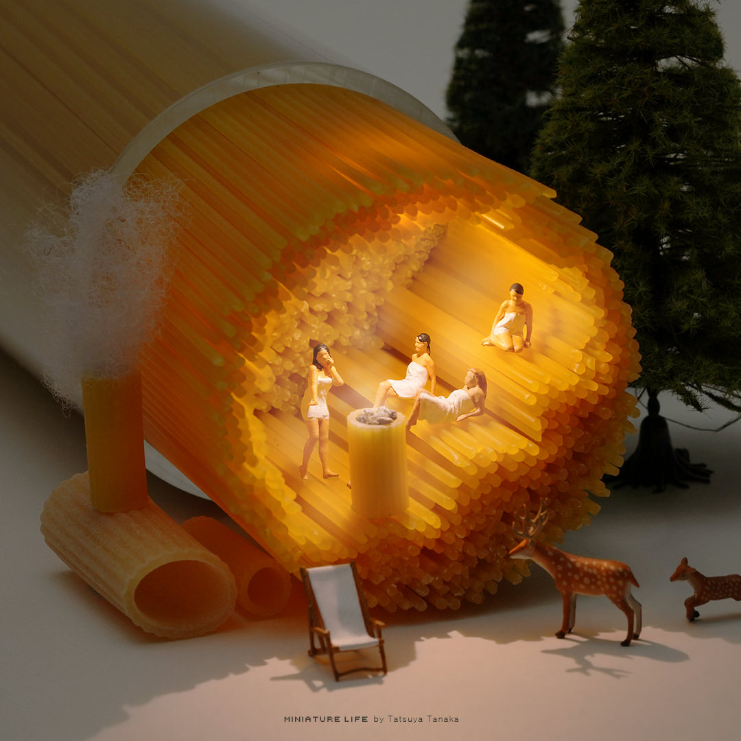 Bundle of dried pasta transformed into a miniature wood-fired sauna with tiny bathers
