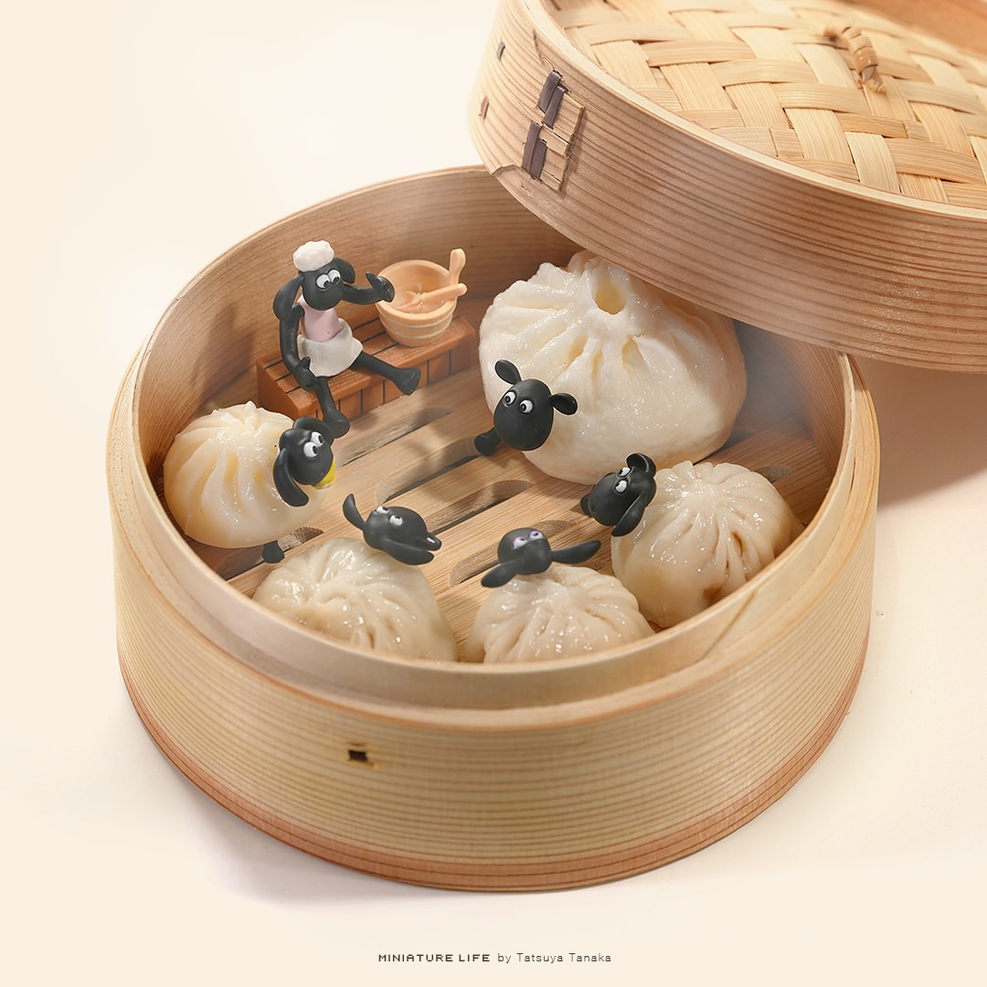 Miniature sheep bathers among soup dumplings in a bamboo steamer bathhouse
