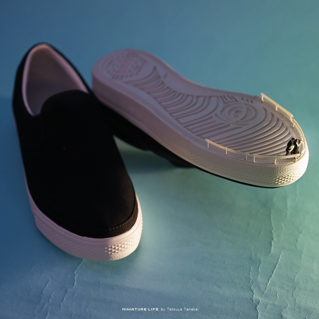 Slip-on sneaker sole transformed into a ship railing with a tiny couple aboard