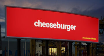 McDonald’s logo-free billboard ad featuring a cheeseburger, from the brand’s minimalist outdoor advertising campaign without logos.