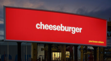 McDonald’s logo-free billboard ad featuring a cheeseburger, from the brand’s minimalist outdoor advertising campaign without logos.