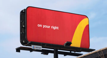 Large red roadside billboard featuring the text “on your right” and a partial yellow McDonald’s Golden Arches curve, demonstrating a logo-free advertising campaign that relies on brand recognition.
