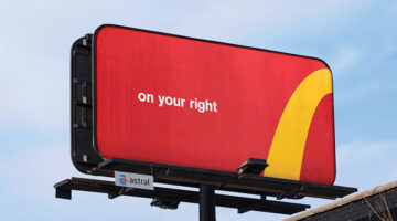 Large red roadside billboard featuring the text “on your right” and a partial yellow McDonald’s Golden Arches curve, demonstrating a logo-free advertising campaign that relies on brand recognition.