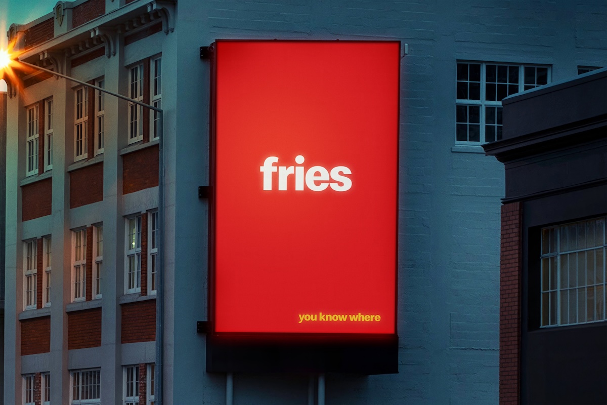 Vertical red billboard with the word “fries” and the line “you know where,” using a minimalist logo-free advertising concept.