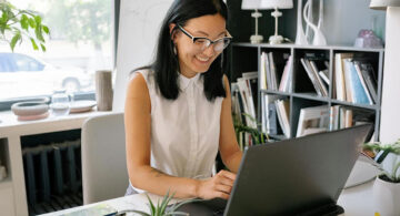 Entrepreneur using a website builder to launch her online business from her office