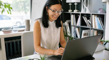 Entrepreneur using a website builder to launch her online business from her office