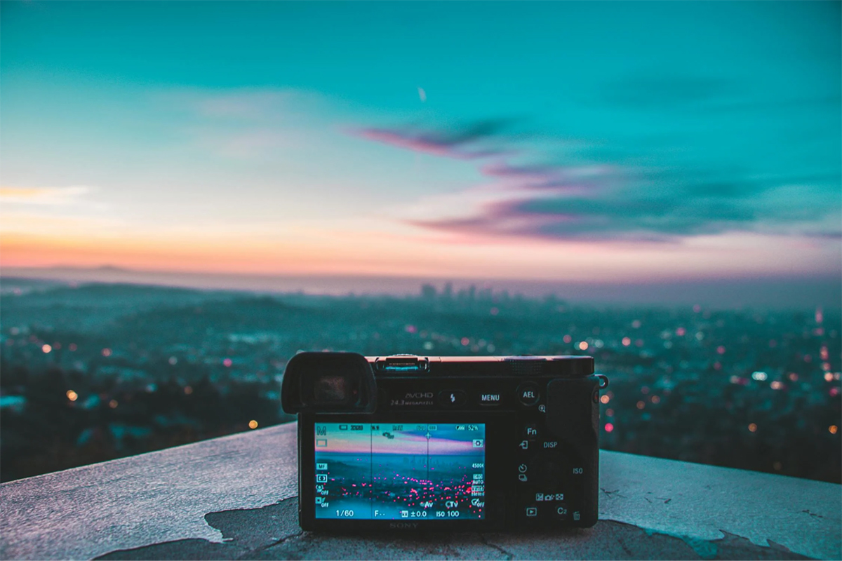 Digital camera capturing a sunset view of a city skyline