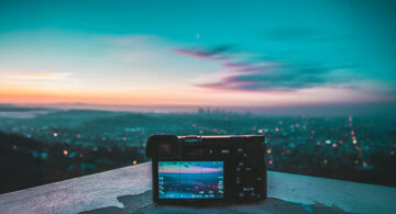 Digital camera capturing a sunset skyline view from above the city