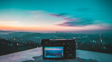 Digital camera capturing a sunset skyline view from above the city