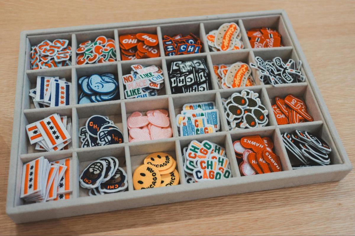 Box of colorful embroidered patches used for brand community giveaways