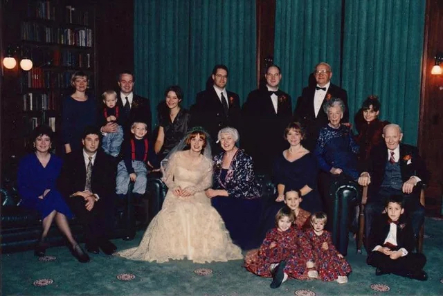 Edited wedding photo with the sister-in-law’s dress recolored and children repositioned to restore focus on the bride