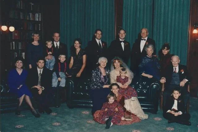 Edited wedding photo with the sister-in-law completely removed, restoring focus on the bride and family