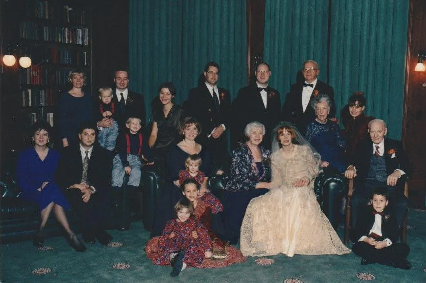 Wedding photo edit with the sister-in-law’s dress color changed and the children repositioned to shift attention back to the bride