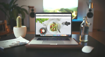 Modern workspace with laptop displaying a clean, responsive website design