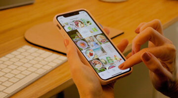 Creative professional browsing Instagram feed on smartphone, exploring link in bio design ideas