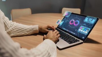 Designer using AI-powered tools on a laptop to automate branding tasks and streamline creative workflows