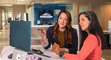 Consultants discussing workflow design and system optimization in an enterprise office environment