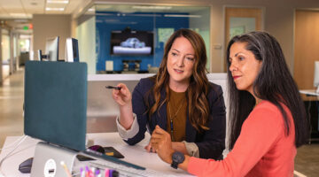 Consultants discussing workflow design and system optimization in an enterprise office environment