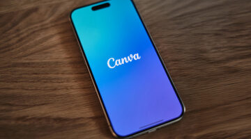 Canva app open on a smartphone placed on a wooden table