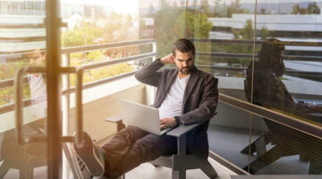 Small business professional working on a laptop while planning a focused marketing page