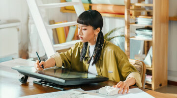 Large drawing tablet setup used by a digital artist for illustration work