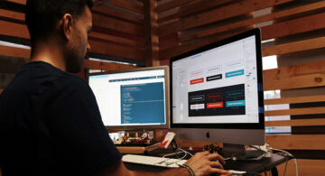 Applying For A Web Design Job? Here's What You Need To Know Web designer working on UI layout and code on dual monitors