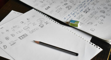 logo design sketches on paper showing branding concepts and ideas