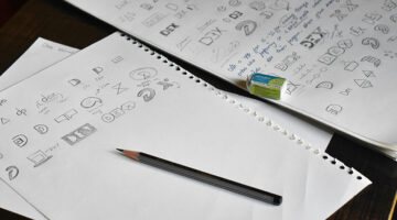 logo design sketches on paper showing branding concepts and ideas