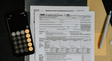 Tax forms, calculator, and folder representing payroll documentation and paystub generator details