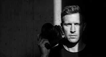 Professional photographer using AI photo editing software for faster photo processing