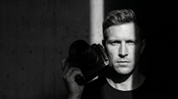 Professional photographer using AI photo editing software for faster photo processing