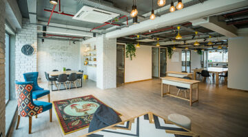 Modern coworking office with creative interior design, collaborative workspaces, meeting areas, and contemporary furnishings