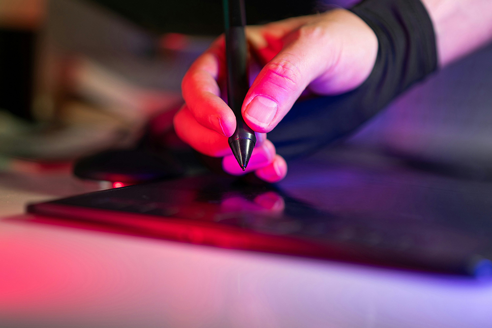 Designer working on a graphics tablet for a freelance client website project