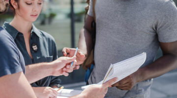 People signing a petition in support of a community cause