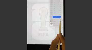 Designer sketching the 2026 FIFA World Cup logo redesign on an iPad, tracing the trophy and numeral shapes in Procreate