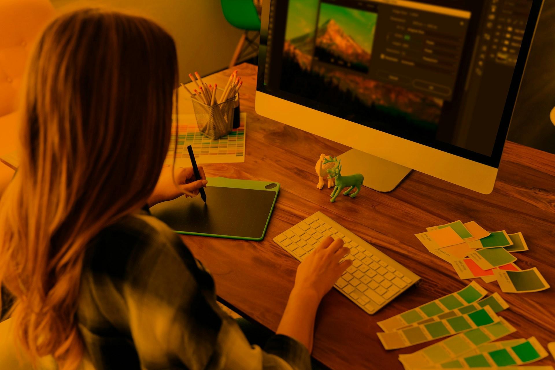 Designer using AI image upscaling tools in a digital design workflow