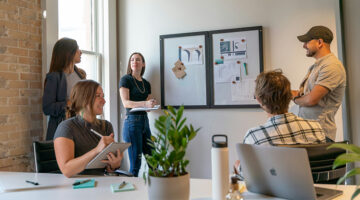 Creative team discussing workflow ideas during a collaborative office meeting