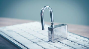 Open padlock on a computer keyboard representing business cybersecurity