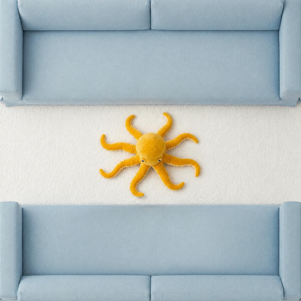 Argentina flag recreated with pale blue sofas, a white rug and a yellow octopus toy using IKEA products