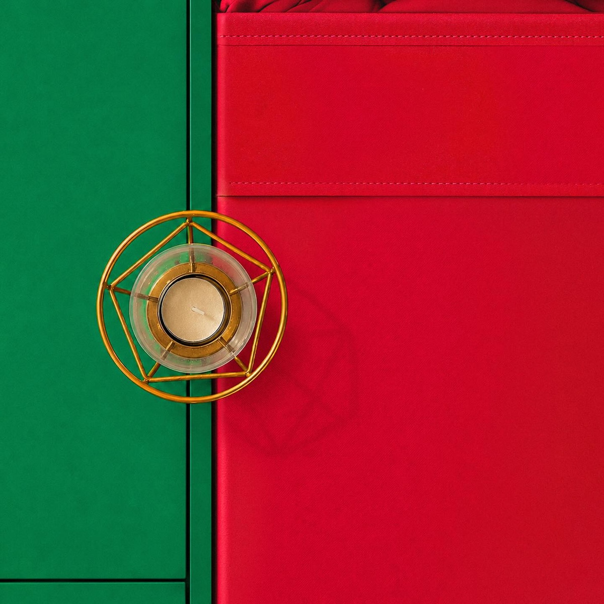 Portugal flag recreated with green and red furnishings and a gold tealight holder representing the national emblem