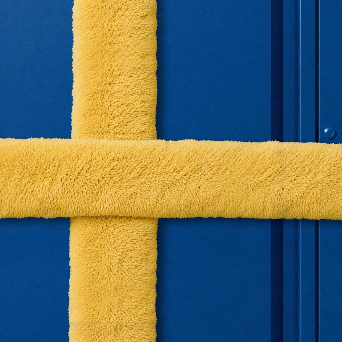 Sweden flag recreated with yellow towels forming a Nordic cross on a blue background