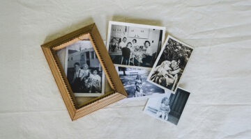 Vintage family photographs and a framed portrait representing personalized art and cherished memories