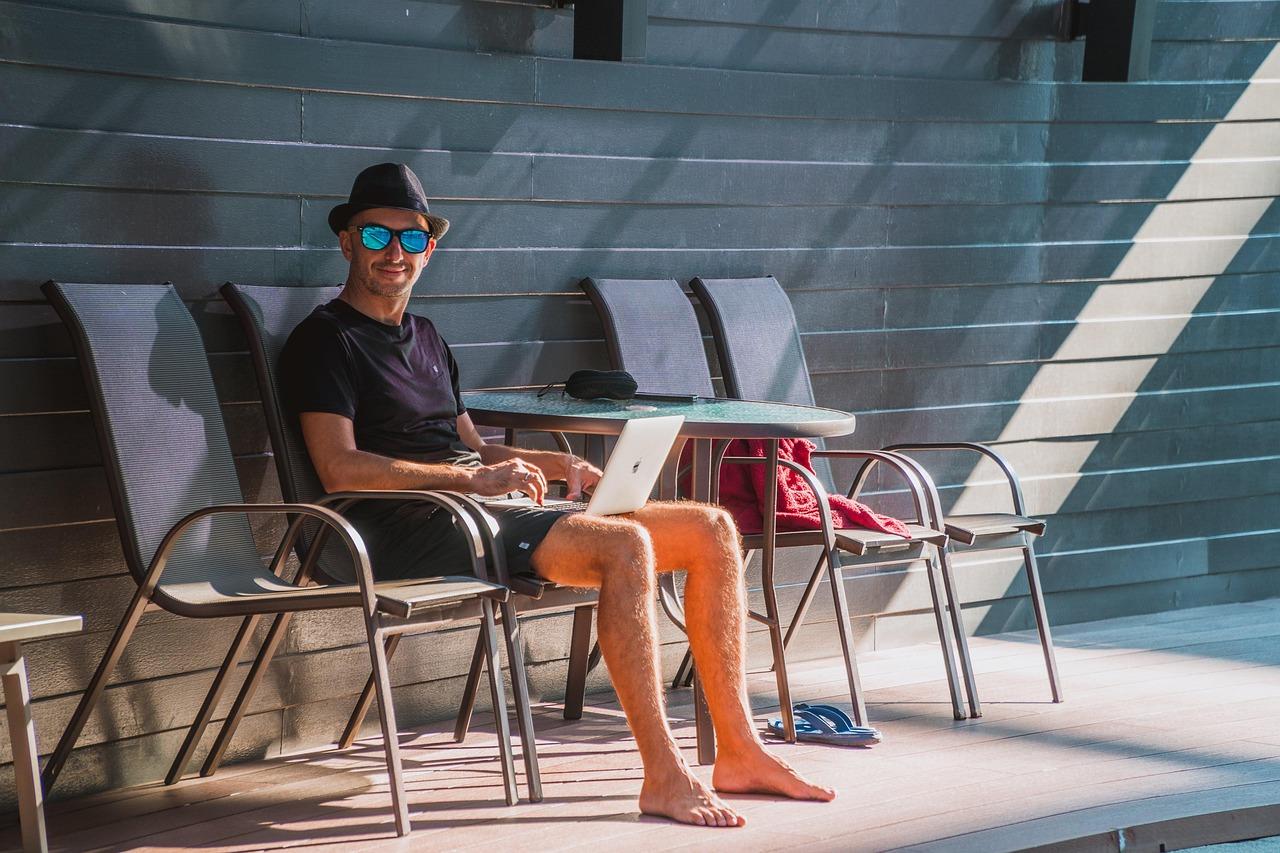 Digital nomad working remotely on a laptop while traveling