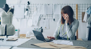 Creative professional working in a design studio on a laptop