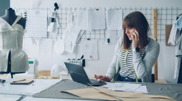Creative professional working in a design studio on a laptop