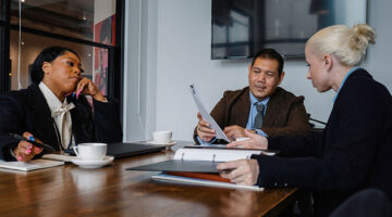 Creative agency team discussing hiring and expansion in Thailand