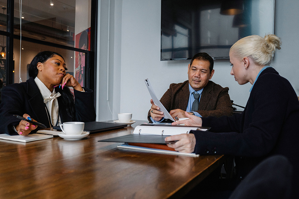 Business team reviewing documents while planning a creative agency expansion in Thailand
