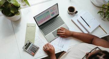 How To Pay Yourself As A Freelancer Freelancer managing income, expenses, and finances on a laptop